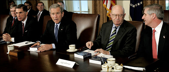 At a meeting this morning, President Bush was flanked by the men who led the commission. At left, Charles S. Robb. At right, Laurence H. Silberman.